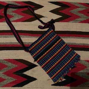 Cute artisanal bag! The bag is 24” long from handle to the bottom of the bag.